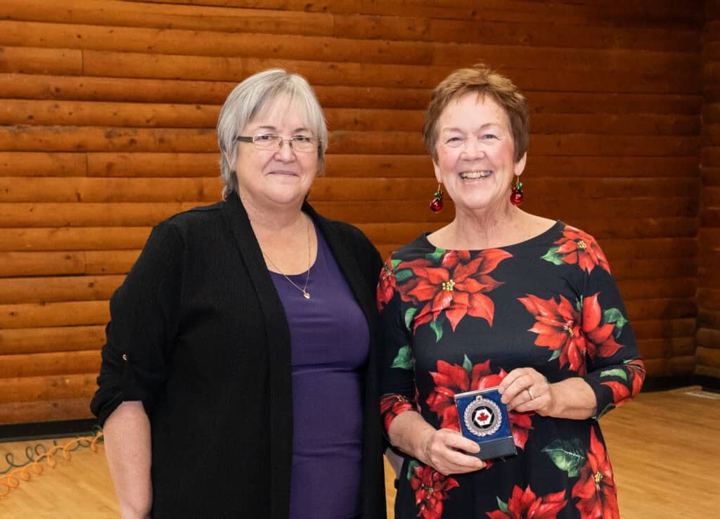 Photograph of Carla Hamilton (President of Langley Camera Club) presenting Lorna Scott with a 2024 Pacific Zone Bronze Medal - Advance Award