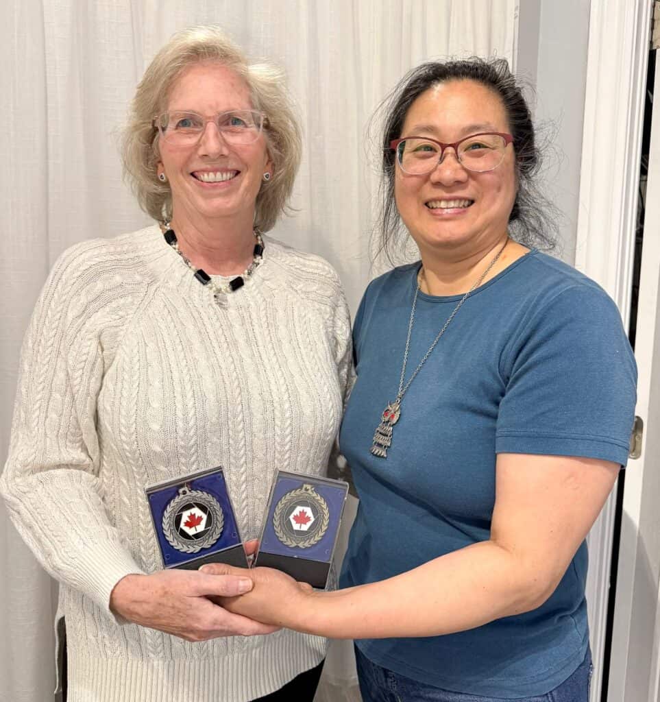 Left to Right: Lynn Fergusson is presented the 2025 Atlantic Zone Individual Competitions' Gold and Silver Medal, by Joyce Chew (CAPA District Rep)